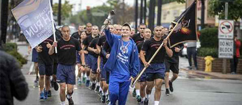Special Olympian Luke Rose of Northridge leads cadets from the Rio Hondo College Police Academy in a run through San Fernando in honor of fallen San Fernando Police officer Jesse Paderez who died in the line of duty in 2002. Photo by David Crane, Los Angeles Daily News - SCNG
