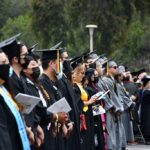 graduate students standing with their cap and gown