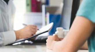 nurse writing notes down on notepad