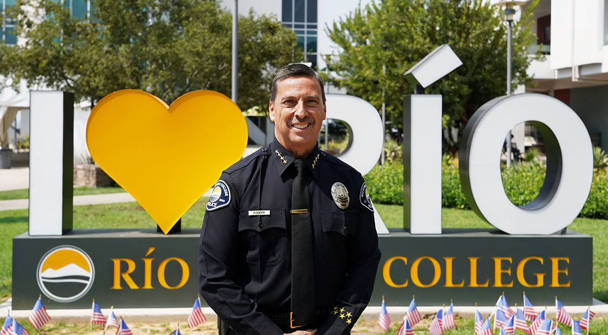 chief todd rogers posing in front of I Love Rio sign