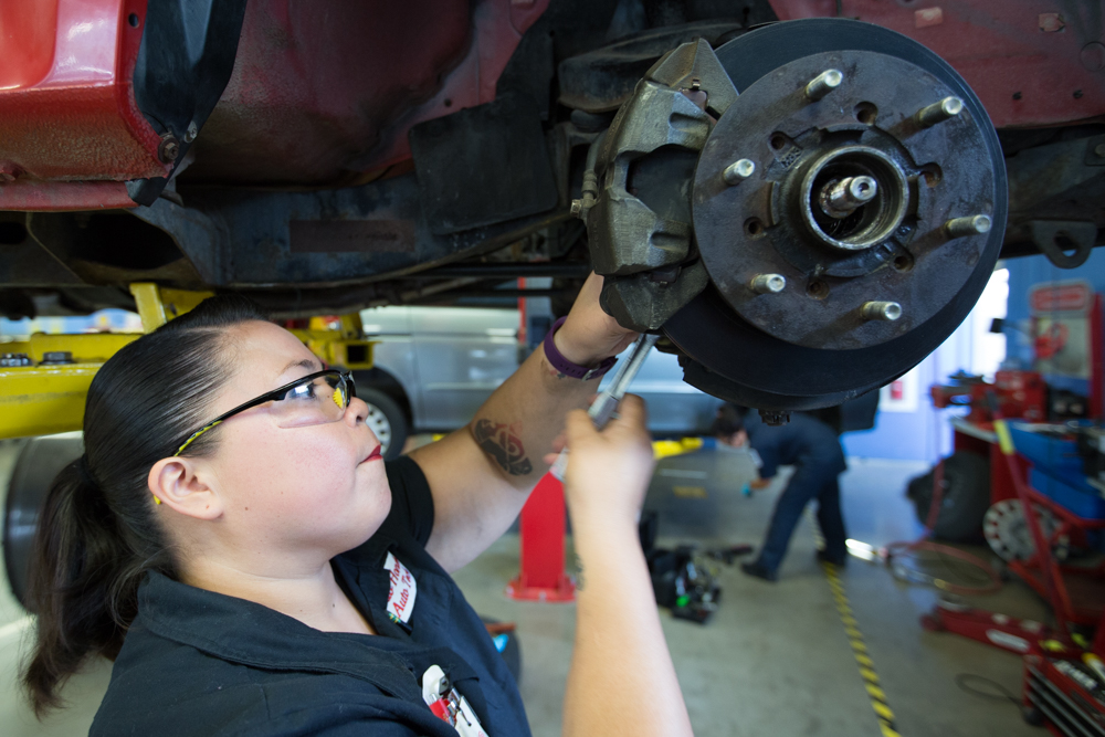 Student wearing protective goggles adjusting the wheels while using diagnostic equipment in Río Hondo’s automotive technology facility