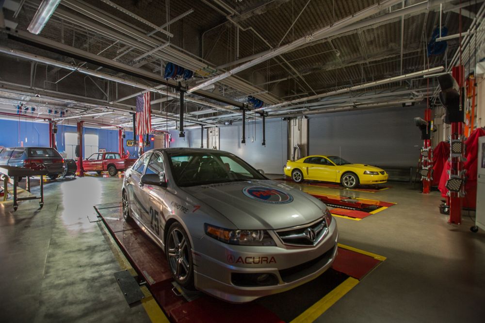 Detailed close-up of a work area in Río Hondo Community College’s automotive technology center, featuring a parked car ready for diagnostics