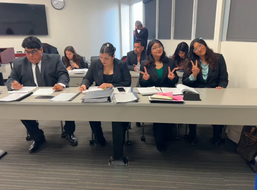 Mock trial students in classroom setting posing for picture